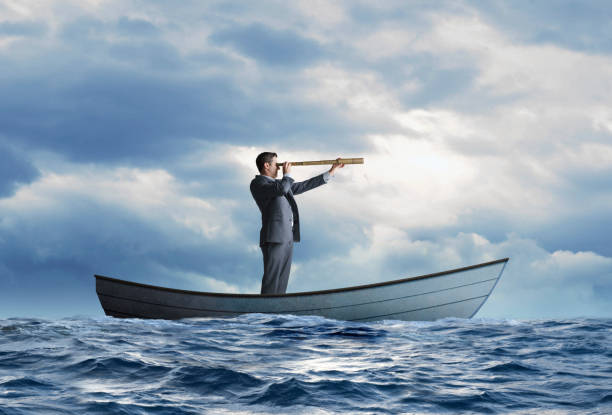 istock Stranded Businessman In Rowboat Searches For Help 1311642412