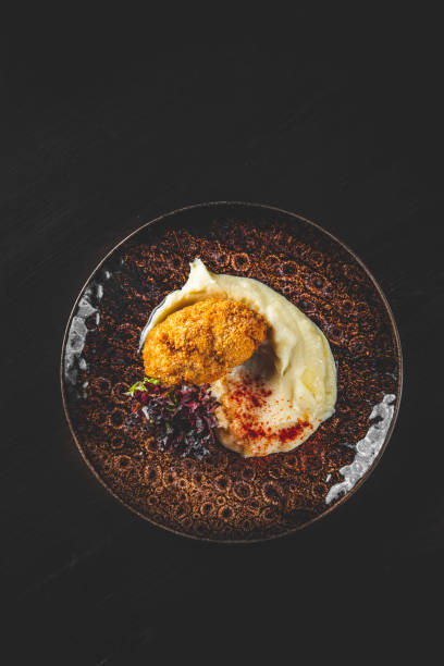 istock burger with mashed potatoes in white on black wooden background 1311643875
