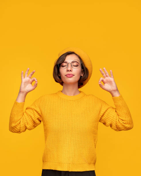 istock Happy young relaxed woman with eyes closed meditating in studio 1311645502