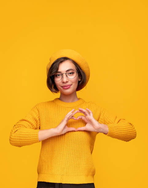 istock Stylish woman showing heart gesture 1311645717