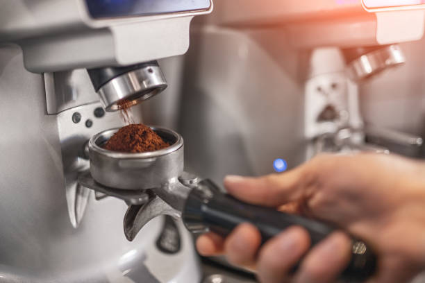 istock Crop barista grinding coffee in cafe 1311645765