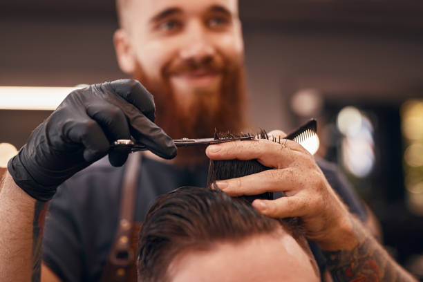 istock Blurred barber cutting hair of client 1311645796