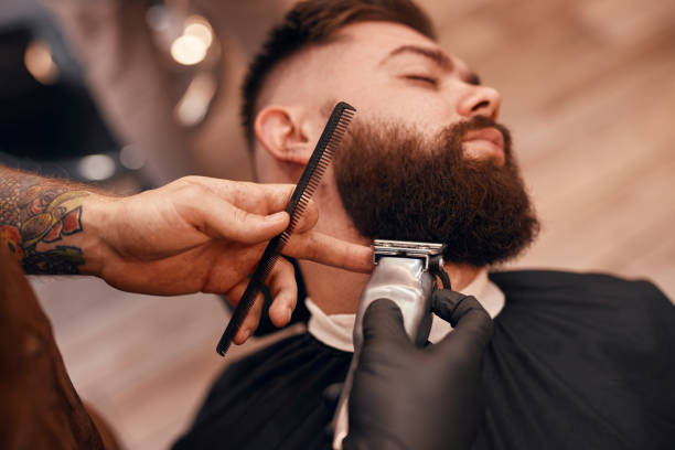 istock Crop barber trimming beard of dandy client 1311645806