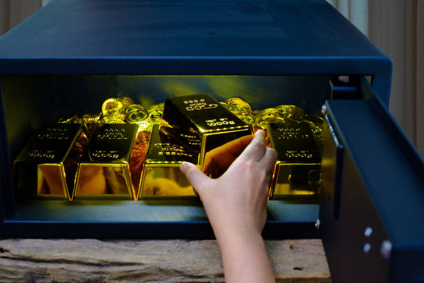 istock Hand open electronics steel safe box full of coins stack and gold bar 1311646083