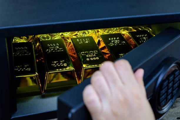 istock Hand open electronics steel safe box full of coins stack and gold bar 1311646084