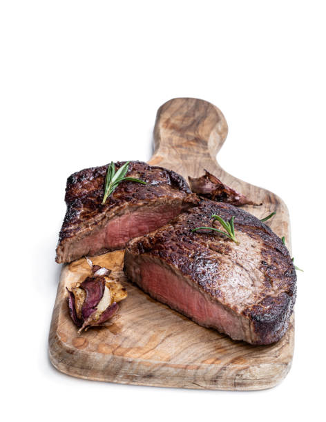 istock Medium grilled beef steak on wooden board isolated on white 1311646942