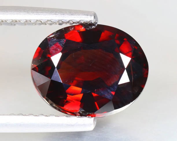 istock Natural gemstone red zircon on gray background 1311647418