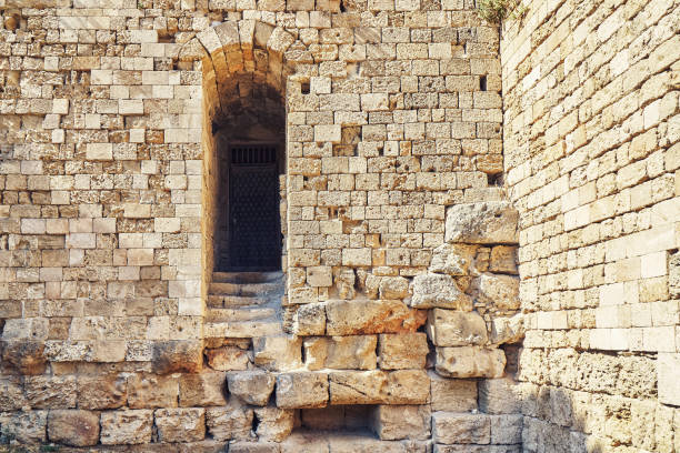 istock Weathered ancient Rhodes fortress stone brick wall 1311647665