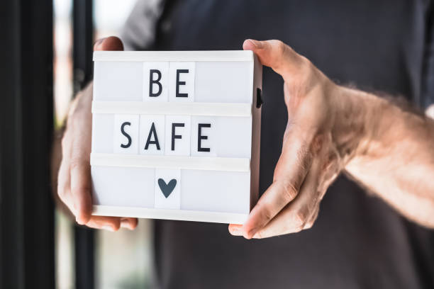 istock Man holding lightbox with text Be safe in his hand 1311648664