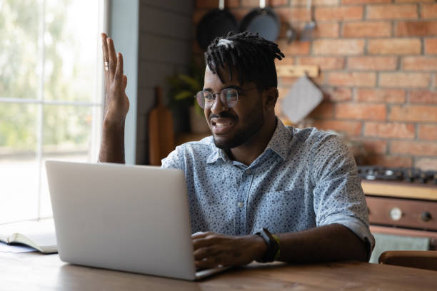 istock Nervous young black male angry with spam on laptop screen 1311649951