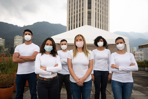 Group of Latin American volunteers wearing facemasks while helping during the COVID-19 pandemic - lifestyle concepts