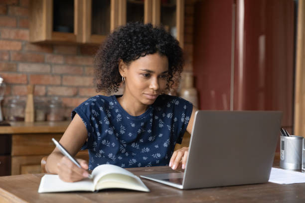 istock African female study by laptop take notes of internet lecture 1311649986