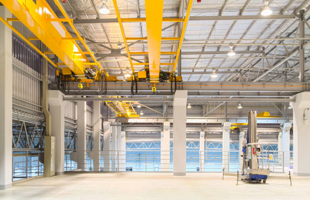 Overhead crane and concrete floor for industrial background. Concrete floor inside factory or warehouse building with empty space for industry background. Overhead crane or bridge crane include hoist lifting for transportation, manufacturing, and production. gantry crane stock pictures, royalty-free photos & images