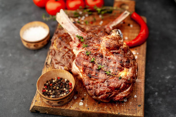 istock grilled beef steak - tomahawk on a stone background. 1311651183