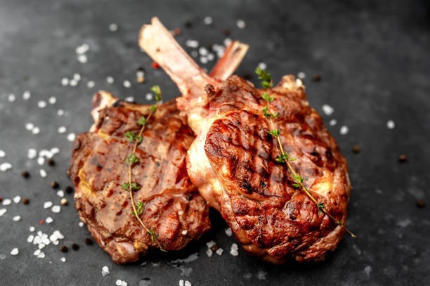 grilled beef steak - tomahawk on a stone background.