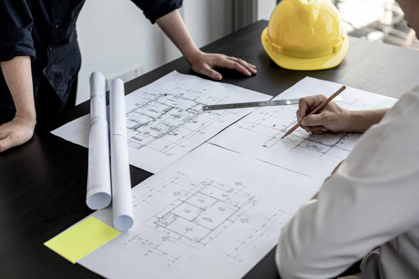 istock The architects and engineers were in a meeting to discuss the draft house plan designed after it was presented to the client. A partial design revision was requested. Interior design and decoration ideas. 1311651247