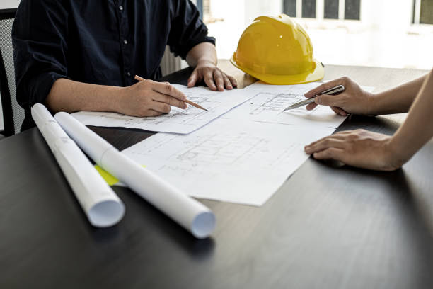 istock Architects and engineers are working together to edit the draft house plan that was designed after it was presented to the client and partially revised the design. Interior design and decoration ideas 1311651713
