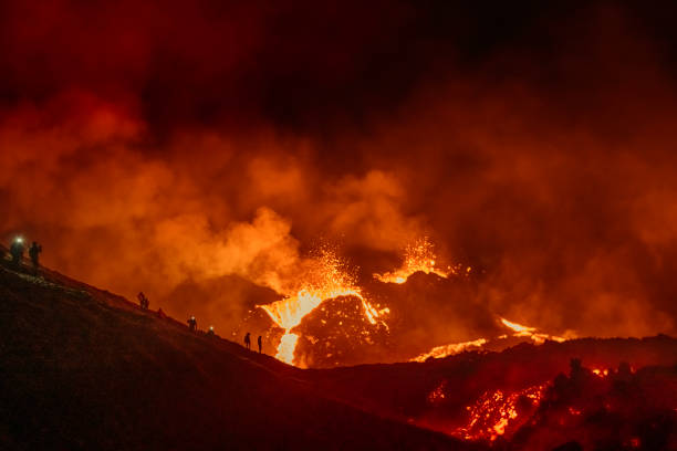 istock People observing a volcano eruption in Iceland 1311652282