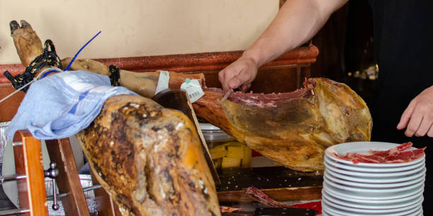 istock the hands of a young person cutting ham 1311652292