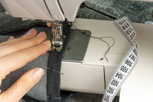 istock process of shortening jeans pants on a sewing machine 1311652312