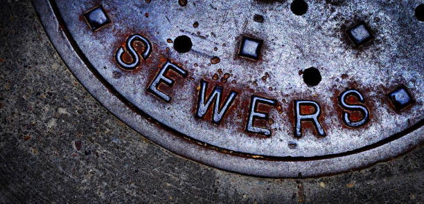 istock Sewer manhole cover maintenance iron steel access to utility 1311652832