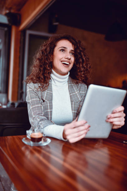 istock Cute Female Having Video Conference On Digital Tablet While Drinking Coffee 1311652862