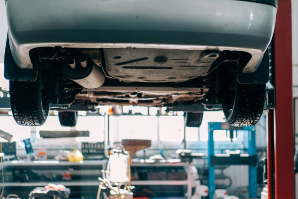 istock Car lifted on car lift for routine maintenance 1311653117