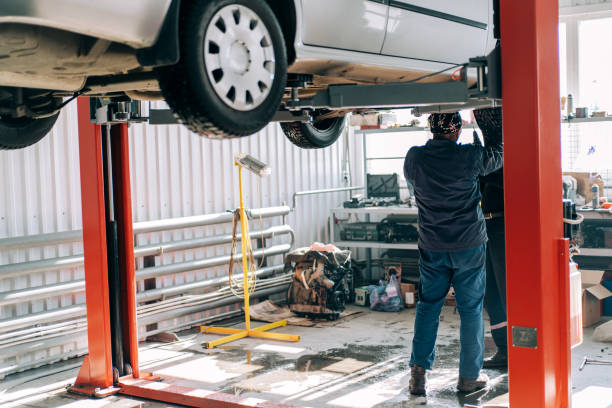 istock Professional mechanic repairs an internal combustion engine and changes the oil. Service station worker 1311653132