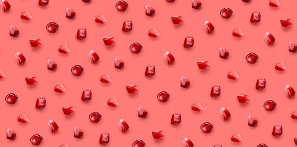 istock Fresh pomegrante seed pattern on pink background, from above 1311653188