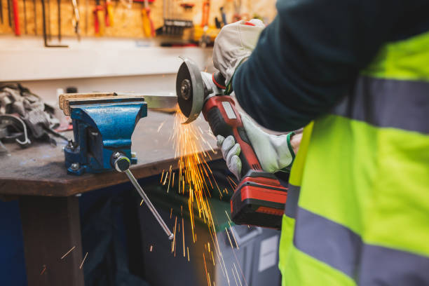 istock Worker with protective gloves working with electric grinder in the workshop. 1311656013