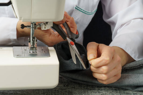 istock the seamstress cuts the thread. the process of cutting and sewing clothes. 1311657464