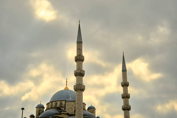 Turkey istanbul 03.03.2021. Blue mosque (sultanahmet) in istanbul and its minarets. many tourists and green trees and grass in front of it during sunset.
