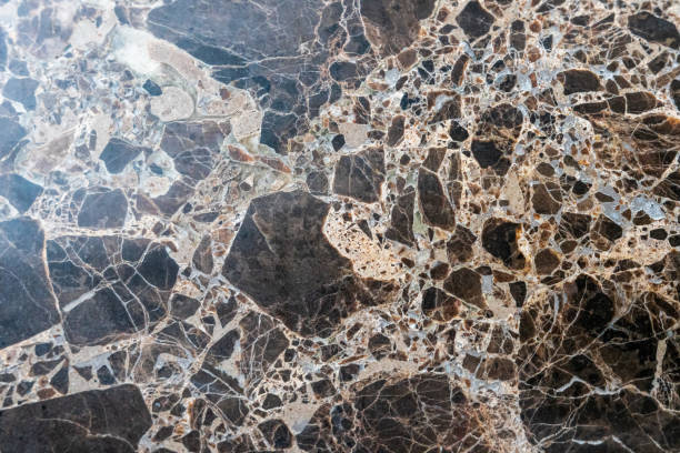 istock cracked black and beige marble stone background and wall texture 1311661332