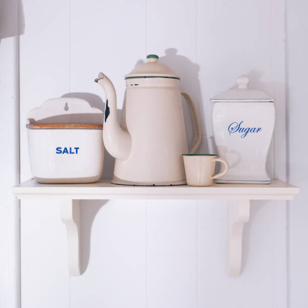 istock Antique kitchen utensils on wooden shelf at wall 1311662656