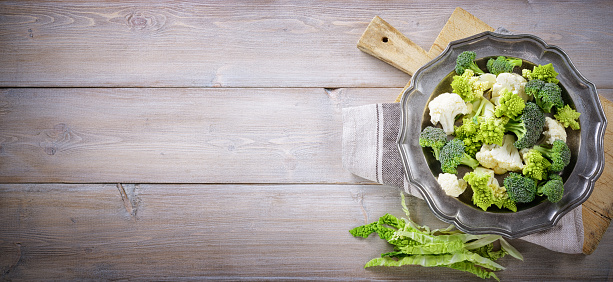 Fresh green vegetables on wooden background, flat lay, space for text.