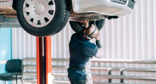 istock Professional mechanic repairs an internal combustion engine and changes the oil. Service station worker 1311664656