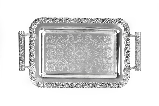 Antique silver tray with handles. Old luxury tray isolated on white background with clipping path. Closeup, top view.