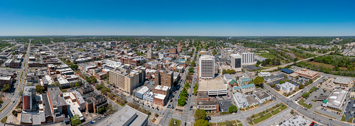 Aerial view of the University of Tulsa with the Tulsa Skyline in the background and beautiful blue skies