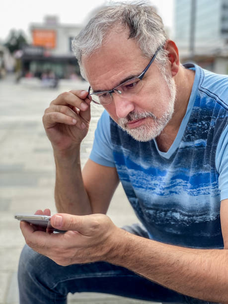 istock Adult man using a smart phone outdoors 1311667668