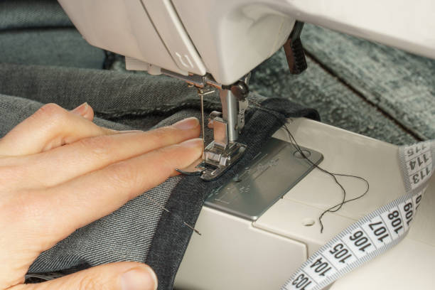 istock process of shortening jeans pants on a sewing machine 1311669384