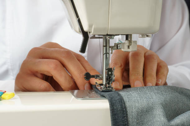 istock process of shortening jeans pants on a sewing machine 1311669415