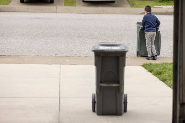 High quality stock photos of a boy taking out the trash at home doing chores