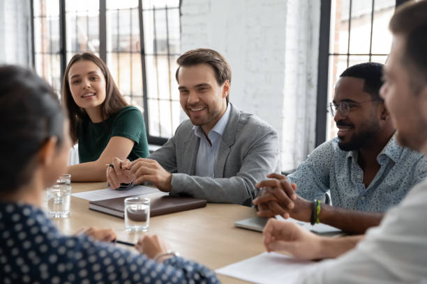 istock Smiling confident multiethnic businesspeople brainstorming at conference desk 1311672620
