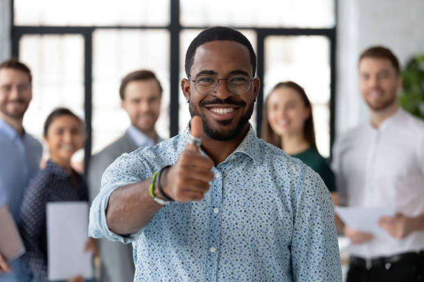 istock Loyal black male client demonstrating thumb up recommending good service 1311672646
