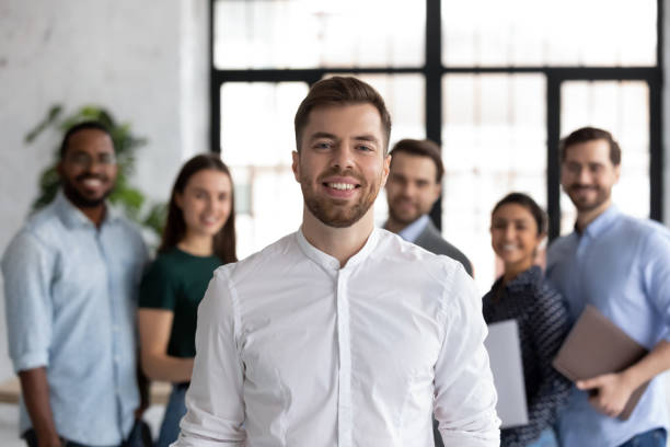 istock Smiling student posing in front of diverse young people group 1311672650