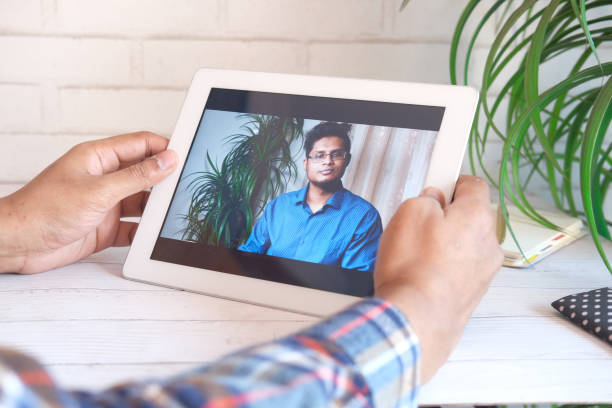 istock businessman holding digital tablet discussing ideas in video conference 1311675039