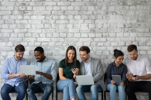 istock Group of diverse multiethnic young people sharing information using wifi 1311675305