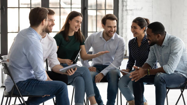istock Friendly female trainer praising black male trainee for correct answer 1311675314
