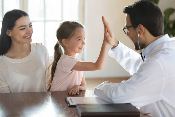 istock Supportive doctor give high five to small girl patient 1311677238