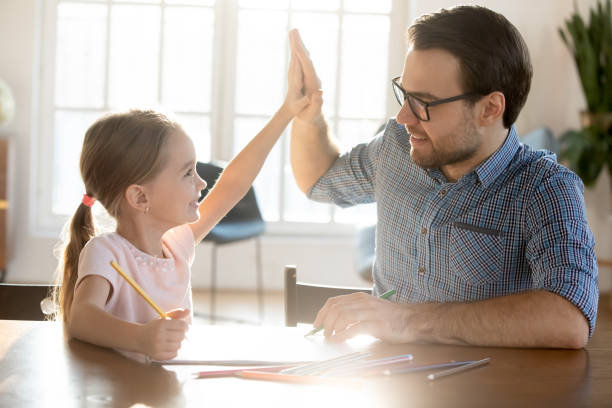 istock Happy young dad and small daughter give high five 1311677282
